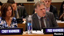Fred Warmbier speaks as his wife, Cindy, looks on during a symposium on international cooperation to urge the Democratic Republic of Korea to take concrete actions to improve its human rights situation, at the United Nations in New York, May 3, 2019.