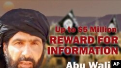 This undated image provided by Rewards For Justice shows a wanted posted of Adnan Abu Walid al-Sahrawi, the leader of Islamic State in the Greater Sahara. 