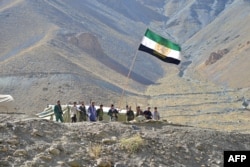 Afghan resistance movement and anti-Taliban uprising forces stand guard on a hilltop in the Astana area of Bazarak in Panjshir province on Aug.27, 2021, as among the pockets of resistance against the Taliban following their takeover of Afghanistan.