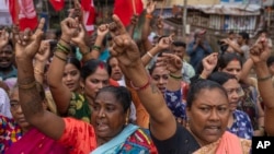 A group of women raise slogans opposing redevelopment of Dharavi, one of Asia's largest slums, through the Adani Group during a protest in Mumbai, India, Aug. 9, 2023.