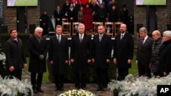 U.S. Secretary of Defence Mark Esper, German President Steinmeier, Luxembourg's Grand Duke Henri, Belgium's King Philippe, and others stand up during a minute of silence during a ceremony to commemorate the 75th anniversary of the Battle of the Bulge.