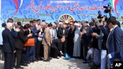 In this photo released by the official website of the Office of the Iranian Senior Vice-President on Sept. 10, 2016, the head of Russia's Federal Atomic Agency Sergei Kiriyenko breaks ground in a ceremony to begin building Iran's second nuclear power plant, near the southern port city of Bushehr, Iran.