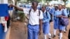 FILE - Students sign out for classes at Wampewo Ntakke Secondary School in Kawempe tula village, Kampala, Uganda, on Nov. 4, 2024. 