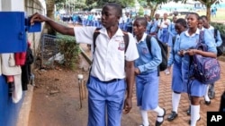 FILE - Students sign out for classes at Wampewo Ntakke Secondary School in Kawempe tula village, Kampala, Uganda, on Nov. 4, 2024. 