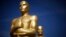 FILE - Oscar statues stand in a parking lot near the Dolby Theater during preparations ahead of the 87th Academy Awards in Hollywood, California.