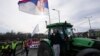 Farmers drive agricultural tractors during a student-led 24 hour block on an intersection to protest the deaths of 15 people killed in the November collapse of a train station canopy, in Belgrade, Serbia, Jan. 27, 2025.