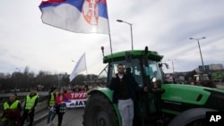 Farmers drive agricultural tractors during a student-led 24 hour block on an intersection to protest the deaths of 15 people killed in the November collapse of a train station canopy, in Belgrade, Serbia, Jan. 27, 2025.