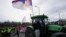 Farmers drive agricultural tractors during a student-led 24 hour block on an intersection to protest the deaths of 15 people killed in the November collapse of a train station canopy, in Belgrade, Serbia, Jan. 27, 2025.