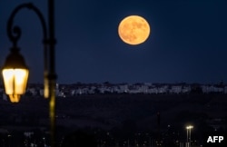 The "Blue Supermoon", the second full moon of a calendar month, rises in the city of Rabat on August 30, 2023. (Photo by FADEL SENNA / AFP)