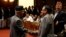 Nepal's Prime Minister Khadga Prasad Sharma Oli, also known as KP Oli, shakes hand with Chairman of the Unified Communist Party of Nepal (Maoist) Pushpa Kamal Dahal, also known as Prachanda, (R) as he returns after announcing his resignation at the parlia