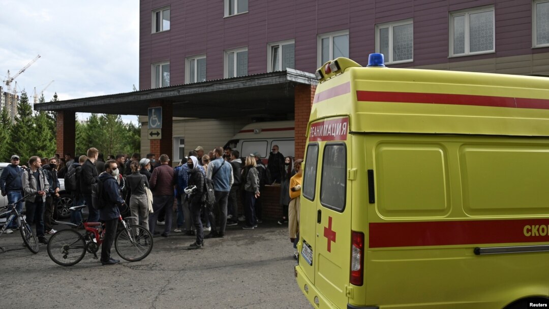 People gather outside a hospital, where Russian opposition leader Alexei Navalny receives medical treatment in Omsk, Russia August 21, 2020.
