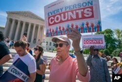 FILE - Immigration activists rally outside the Supreme Court as the justices hear arguments over the Trump administration's plan to ask about citizenship on the 2020 census, in Washington, April 23, 2019.