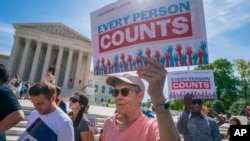 Immigration activists rally outside the Supreme Court as the justices hear arguments over the Trump administration's plan to ask about citizenship on the 2020 census, in Washington, Tuesday, April 23, 2019. 
