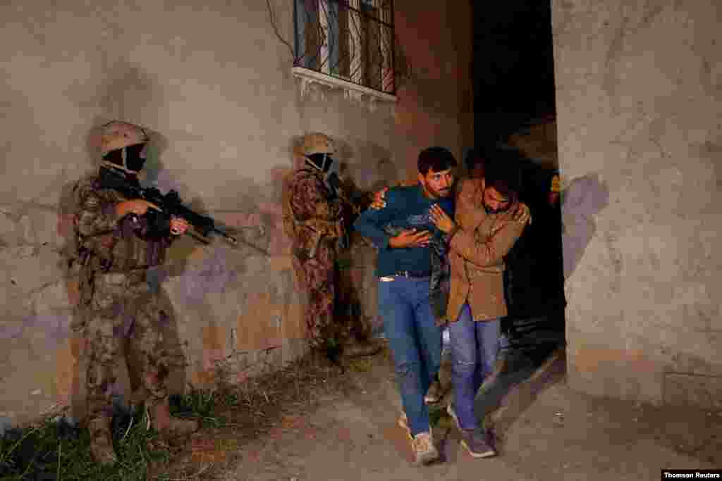 Migrants, mainly from Afghanistan, are seen after they were detained by Turkish security forces during an operation in the border city of Van.