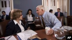 House Rules Committee Chairman Pete Sessions, center, confers with Rep. Louise Slaughter, the top Democrat, as the panel meets on Capitol Hill in Washington, Dec. 21, 2017.