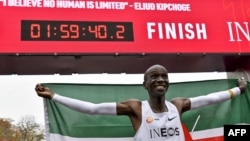 Kenya's Eliud Kipchoge celebrates after breaking the two-hour barrier for the marathon, Oct. 12, 2019, in Vienna. 