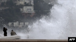 People watch giant waves, on Dec. 25, 2013 in Nice, southeastern France. 