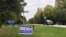 FILE - Signs for Democratic presidential candidate former Vice President Joe Biden and President Donald Trump mark neighboring properties in a middle-class neighborhood of Oshkosh, Wisconsin, Sept. 29, 2020. 