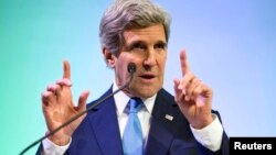 U.S. Secretary of State John Kerry gestures while speaking about climate change in Jakarta, Feb. 16, 2014.