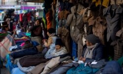 Women sell coats in downtown La Paz, Bolivia, June 4, 2019. The number of people who joined the informal sector has swelled to about 50%, one of the region’s highest.