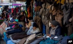 Women sell coats in downtown La Paz, Bolivia, June 4, 2019. The number of people who joined the informal sector has swelled to about 50%, one of the region’s highest.