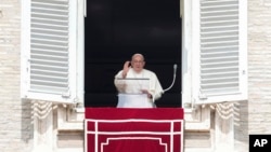 Pope Francis waves during the Angelus noon prayer from the window of his studio overlooking St. Peter's Square, at the Vatican, Sept. 22, 2024. The pope will be traveling to Luxembourg and Belgium Sept. 26-29. 