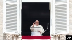 Pope Francis waves during the Angelus noon prayer from the window of his studio overlooking St. Peter's Square, at the Vatican, Sept. 22, 2024. The pope will be traveling to Luxembourg and Belgium Sept. 26-29. 