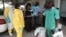 FILE - A health worker sprays a colleague with disinfectant during a training session for Congolese health workers to deal with Ebola virus in Kinshasa, Oct. 21, 2014. The Democratic Republic of Congo had declared a two-month ebola outbreak over.