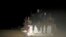 FILE - Migrants sit at the back of a truck as it is driven through a dust road at night in the desert town of Agadez, Niger, May 25, 2015.