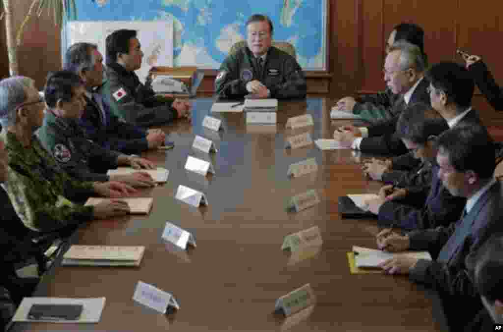 Japan's Defense Minister Satoshi Morimoto, center, talks during a meeting with the ministry's top officials at the defense ministry in Tokyo, Wednesday, Dec. 12, 2012.