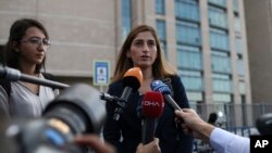 FILE - German journalist Mesale Tolu (C) talks to members of the media outside a court in Istanbul, Turkey, Oct. 16, 2018, prior to her trial on terror charges.