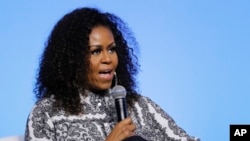 FILE - In this Dec. 12, 2019, file photo, former first lady Michelle Obama speaks during an event for Obama Foundation in Kuala Lumpur, Malaysia. Seeking to unite Democrats, Joe Biden has raced to line up supporters ranging from progressive icon…