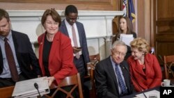 Senate Judiciary Committee member, Sen. Amy Klobuchar (L), joins Senate Minority Leader Harry Reid (C) and Sen. Debbie Stabenow at a meeting on Capitol Hill, April 6, 20116, to discuss Judge Merrick Garland's nomination to the US Supreme Court.