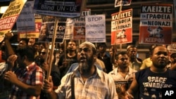 Migrants shout slogans during an anti-fascist rally, commemorating the killing of Greek rap singer Pavlos Fyssas four years ago, in Athens, Sept. 16, 2017. About 3,000 leftist activists and migrants marched through central Athens Saturday to honor the memory of Fyssas, murdered by a neo-Nazi sympathizer, and Heather Heyer, the activist killed by a car that rammed into a group of people at Charlottesville, Va., last month.