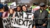 FILE - Women protest after more than 80 men suspected of the gang rapes of eight women appeared in court, outside the Krugersdorp Magistrate Court in South Africa, Aug. 1, 2022.