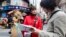 A Japanese tourist (R) speaks to a volunteer interpreter in Central Seoul April 8, 2013.