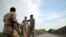 Members of Amhara special forces stand guard on the Tekeze river bridge near Ethiopia-Eritrean border near the town of Humera, Ethiopia, July 1, 2021. 