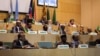 FILE - African Union Chairman Moussa Faki, second left at top, sits with members of the Intergovernmental Authority for Development as they attend a signing ceremony for a cease-fire agreement among South Sudanese parties to end the four-year war in the country, at the headquarters of African Union in the Ethiopian capital, Addis Ababa, Dec. 21, 2017. South Sudan peace talks were adjourned for several weeks on Feb. 16, 2018.