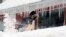 Corbit Larson clears snow in front of his Centre Music store in Framingham, Massachusetts. A long duration winter storm that began on Feb. 7 night remains in effect for a large swath of southern New England until the early morning hours on Feb. 10, 2015.
