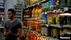 A man waits for customers at a grocery store in Cairo, Egypt, Oct. 26, 2016.