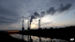 Smoke rises from chimneys of the Turow power plant located by the Turow lignite coal mine near the town of Bogatynia, Poland.