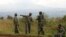 Soldiers from the Democratic Republic of Congo (DRC) rest near the town of Kibumba at its border with Rwanda after fighting broke out in the Eastern Congo town, June 11, 2014.