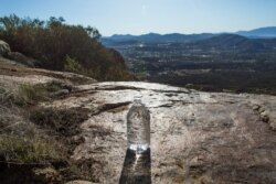 Water is left by volunteers of the nonprofit Border Angels in a remote area of the mountains near the end of the fence at the U.S.-Mexico border, in Tecate, California, on Dec. 29, 2018.