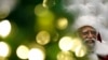 Dressed as Santa Claus, Langston Patterson, 77, poses for photos at Baldwin Hills Crenshaw Plaza mall in Los Angeles, Dec. 16, 2013