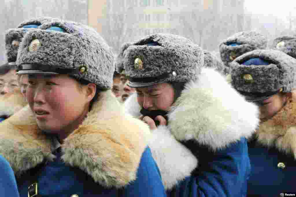 North Korean traffic control women react to the news of Kim Jong-il's death in Pyongyang, December 21, 2011. (Reuters/Kyodo)