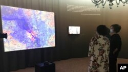 Audrey Azoulay, UNESCO's director general, right, attends the exhibit "Revive the Spirit of Mosul," in Venice, Italy, May 21, 2021. (UNESCO via AP)