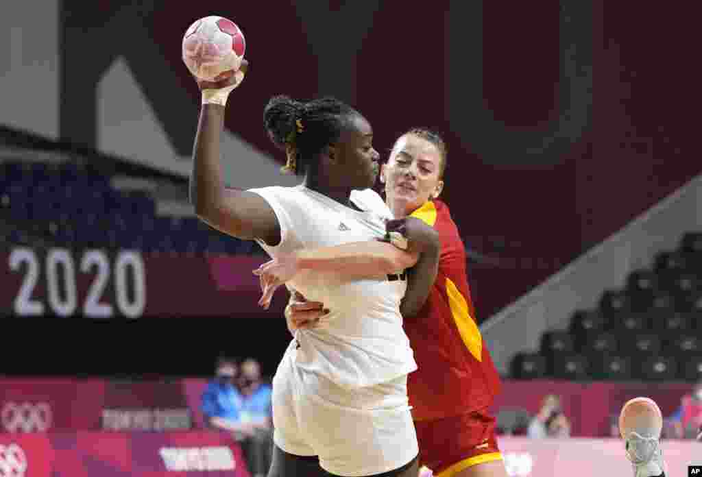 Angola&#39;s Liliana Venancio, left, challenges for the ball with Montenegro&#39;s Jelena Despotovic during the women&#39;s preliminary round group A handball match between Montenegro and Angola at the 2020 Summer Olympics, Sunday, July 25, 2021, in Tokyo, Japan. (AP Photo/Sergei Grits)