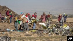 FILE: Rescuers work at the scene of an Ethiopian Airlines flight crash near Bishoftu, or Debre Zeit, south of Addis Ababa, Ethiopia. Taken March 11, 2019