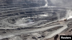 FILE - Miners are seen at the Bayan Obo mine containing rare earth minerals, in Inner Mongolia, China, July 16, 2011. China dominates the critical minerals sector, but Australia has announced a plan to mine and process the minerals.