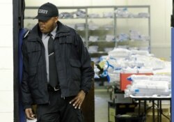A Milwaukee County sheriff guards a room where ballots are stacked up as a statewide presidential election recount begins Thursday, Dec. 1, 2016, in Milwaukee. The first candidate-driven statewide recount of a presidential election in 16 years began…